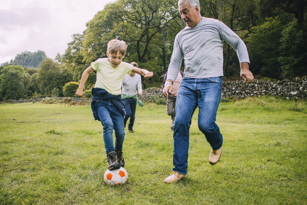 Tips To Reduce Your Risk of Cancer: Father and son playing football